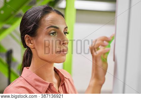 Portrait Of Young Woman Using Control Panel While Operating Self Storage Unit, Copy Space