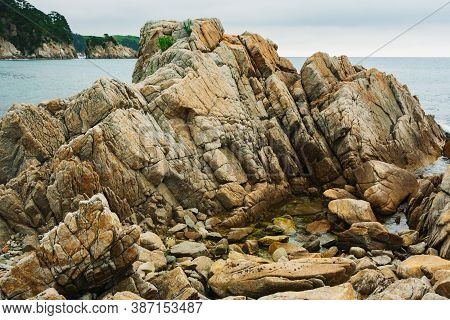 Rocky Seashore, Cloudy Weather At Sea, Coastline Of Telyakovsky Bay Primorsky Krai, Russia.