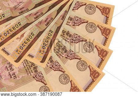10 Nepalese Rupees Bills Lies Isolated On White Background With Copy Space Stacked In Fan Shape Clos