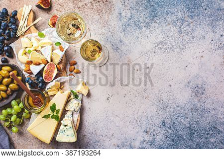 Cheese Plate Served With Fruits, Honey And Snacks. Assorted Cheese Background.