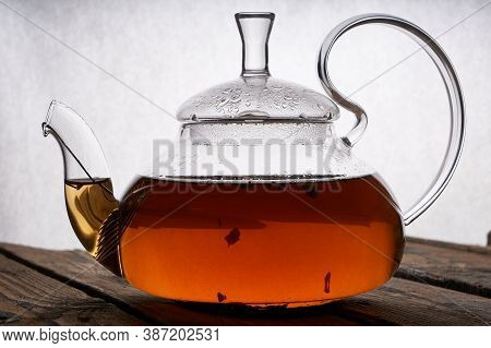 Teapot With Brewed Hot Tea On A Wooden, Cozy Background