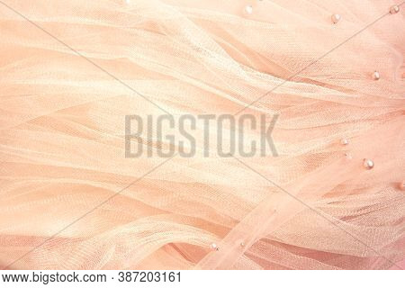 Beautiful Nude Pink Tulle With Shiny Beads Background. Draped Background Of Pink Powdery Fabric, Tex