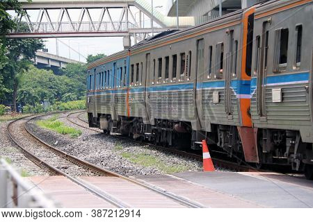 Train Running On Rails In Thailand, Metal Railway Of Train Parallel With Railway Of Electric Train.