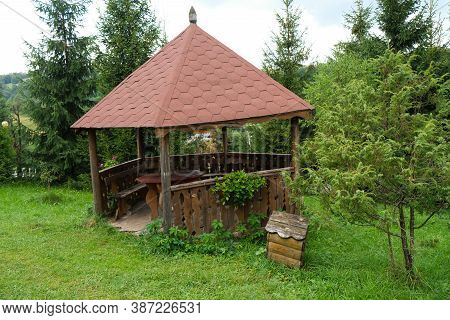 Gazebo In Garden On Cotage Backyard. Green Grass Around
