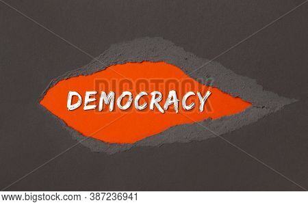 Democraty - The Inscription Appears Behind The Torn Paper.