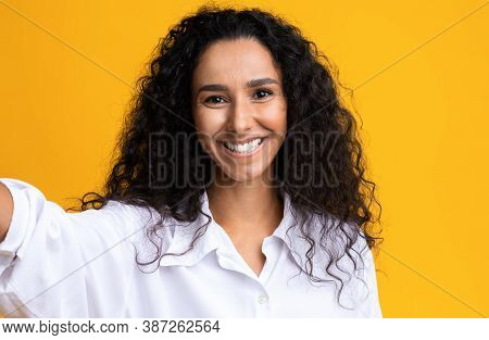 Joyful Beautiful Brunette Woman Taking Selfie, Capturing Photo, Making Self-portrait, Posing Over Ye