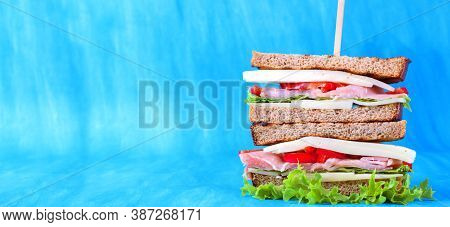 Multilayered Club Sandwich With Cheese, Pork Balyk, Bell Pepper, Lettuce Leaves And Toasted Bread Ag