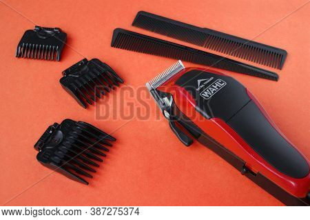 Kharkov, Ukraine - July 2, 2020 : Hairdressers Tool. Hair Clipper Wahl Close-up On A Red Background 