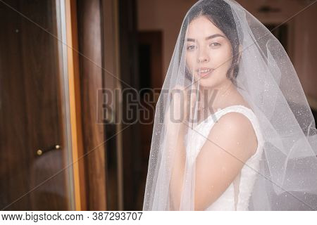 Bride On The Veil Stand By The Window And Wait For The Goom