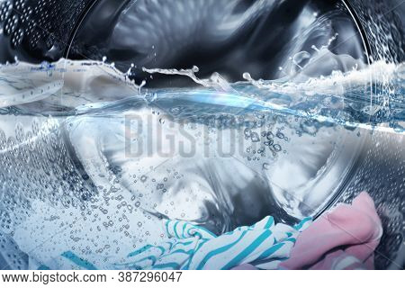 Washing Machine Drum With Water And Clothes, Closeup View
