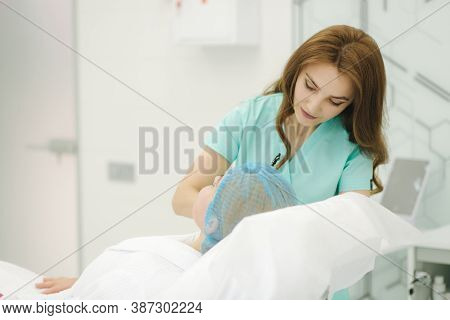 Hands Of Cosmetologist Making Preparation For Face Contouring Plasty. Young Woman Gets Beauty Facial