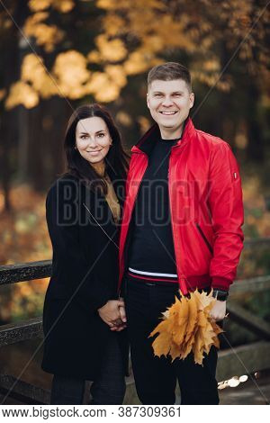 Couple In Love Goes For A Walk In The Autumn Park Together