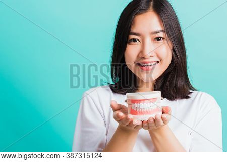 Portrait Of Asian Teen Beautiful Young Woman Smile Have Dental Braces On Teeth Laughing She Holding 