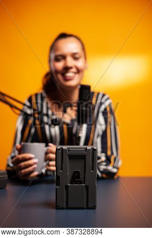Videographer Filming Battery With V-lock During Podcast. Professional Videography Gear Review By Con
