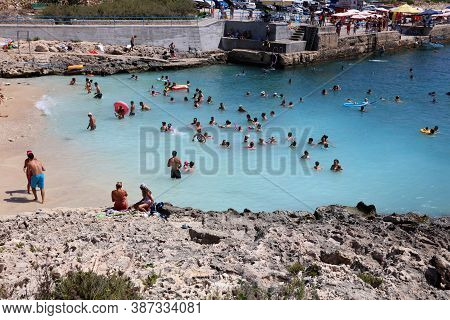 Qala, Malta - August 15, 2019: Many Unidentified People On The Beach Of Hondoq Bay. Island Of Gozo. 