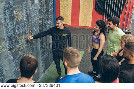 Coach Explaining To A Group Of Athletes In The Gym