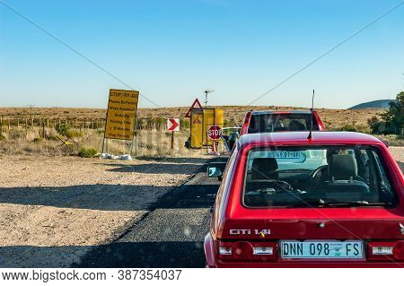 Upington, South Africa - June 04, 2012: A Stop And Go Delay At Road Works On Road N10 Between Groble