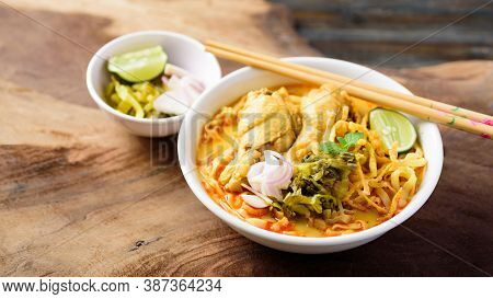 Northern Thai Food (khao Soi), Spicy Curry Noodles Soup With Chicken Eating With Crispy Deep-fried E