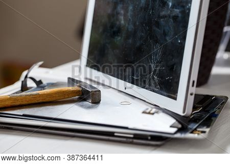 The Hammer Hits The Broken Touchscreen Tablet, Suggesting That It Is About To Replace It. Broken Gla