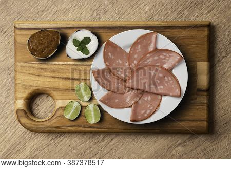 Mortadella Slices Appetizer, Served With Lemon And Pepper Sauce