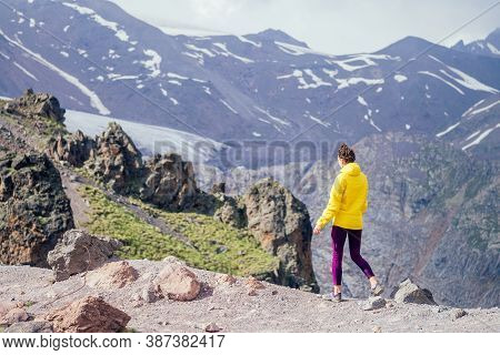Happy Free Woman In Yelllow Jacket In Summer Elbrus
