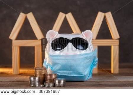Pandemic Real Estate Crisis. Masked Piggy Bank