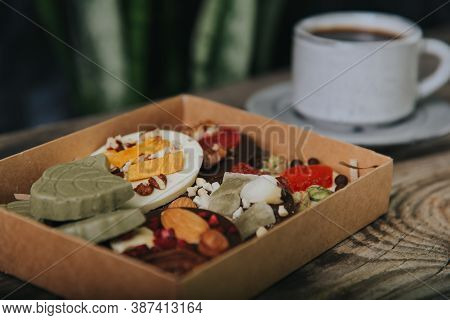 Chocolates With Dried Fruits In A Craft Box And A Cup Of Espresso Coffee.