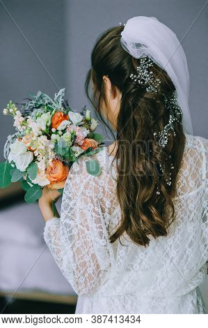 Bride In Wedding Dress With Wedding Bouquet In Hands