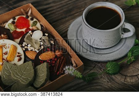 Chocolates With Dried Fruits In A Craft Box And A Cup Of Espresso Coffee.