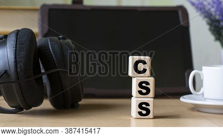 Css (cascading Style Sheets) -acronum On Cubes On The Background Of The Tablet, Headphones And A Whi