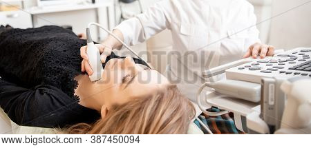 Doctor Conducts Ultrasound Examination Of Woman Thyroid Gland In Clinic, Lack Of Iodine