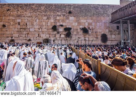 JERUSALEM, ISRAEL - SEPTEMBER 26, 2018: Blessing of the Kohanim. Women praying at the Wailing Wall behind the fence. The area in front of Western Wall of Temple filled with people