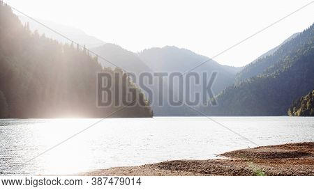Rizza Lake In The Golden Hour. Tourist Attraction Of Abkhazia. Mountain Lake.