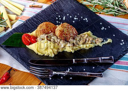 Mashed Potatoes With Cream Mushroom Sauce And Chopped Cutlet Are On The Plate