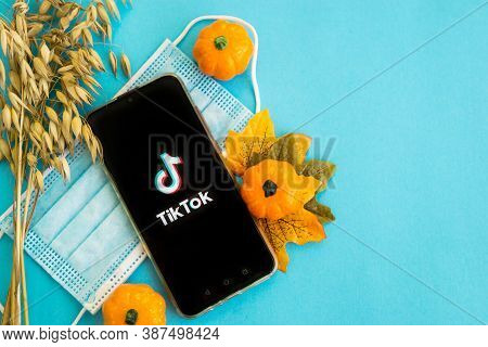 Tver, Russia - September 25, 2020, Medical Mask, Pumpkins And Tik Tok Logo On The Smartphone Screen 