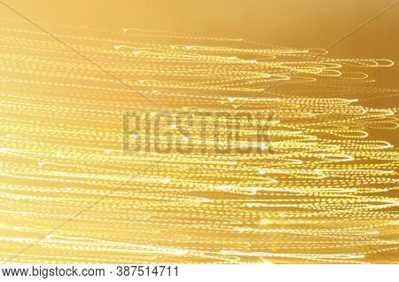 Long Esposure Speed Of Lights In Golden Color And Various Shape. Abstract Festivebackground