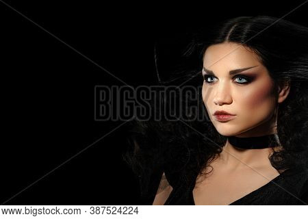 Bright Attractive Female Brunette Posing In Witch Halloween Costume