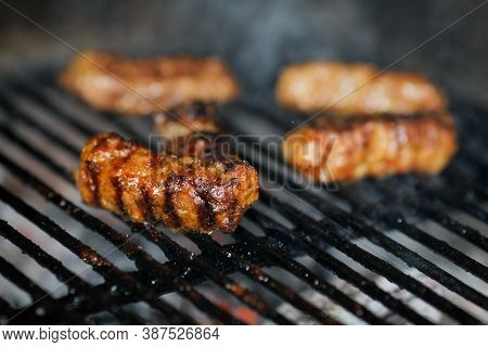 Shallow Depth Of Field (selective Focus) Image With Romanian Traditional Mici (mititei), Grilled Gro