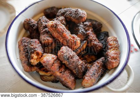Shallow Depth Of Field (selective Focus) Image With Romanian Traditional Mici (mititei), Grilled Gro