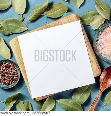 A Square Design Template For A Recipe, Kitchen Flat Lay On A Blue Background, With Bay Leaves, Salt,