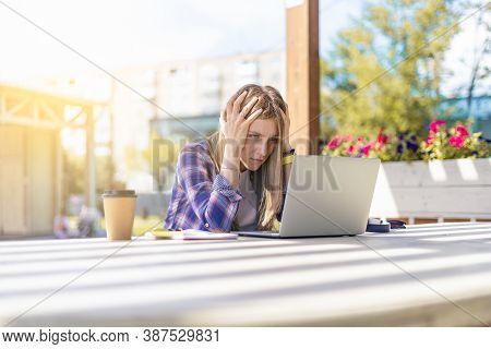Tired Woman Working With Laptop Outside In Park.