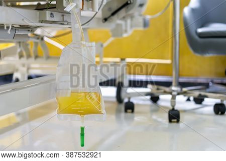 Transparent Urine Plastic Bag And Pee Catheter Hang Under Patient Bed In Hospital