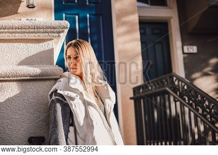 Portrait Of Stylish Woman With Straight Long Hair Wearing Grey Sweatshirt And White Waistcoat. Young