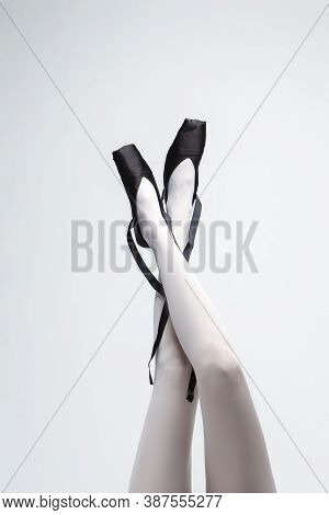 Ballet Dancer Legs In Laced Pointes Shoes. Posing With Straight And Crossed Legs.