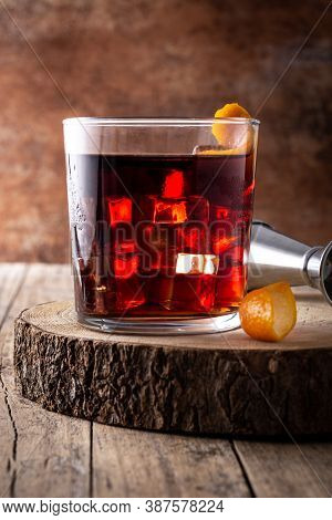 Boulevardier Cocktail And Orange Zest On Rusty Background.