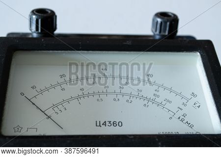Scale With An Arrow On An Old Electrical Device.