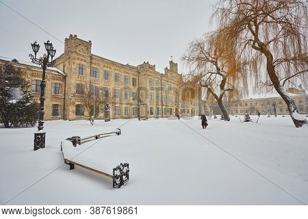 A Snow Covered Bench In A Park