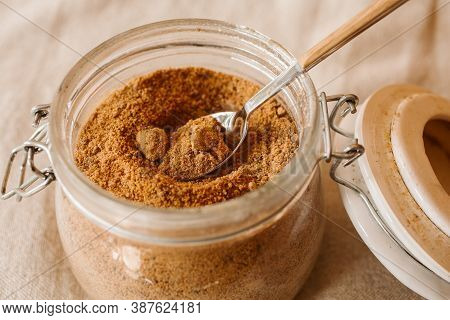 Panela Sugar Background. Close Up View Of Raw Cane Sugar In A Jar.