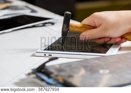The Hammer Hits The Broken Touchscreen Tablet, Suggesting That It Is About To Replace It. Broken Gla