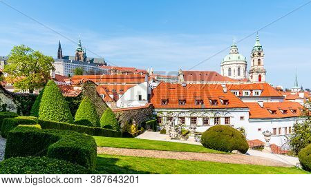 Prague Castle And St Nicholas Church In Lesser Town Of Prague. Sunny Spring Day View From Vrtba Gard